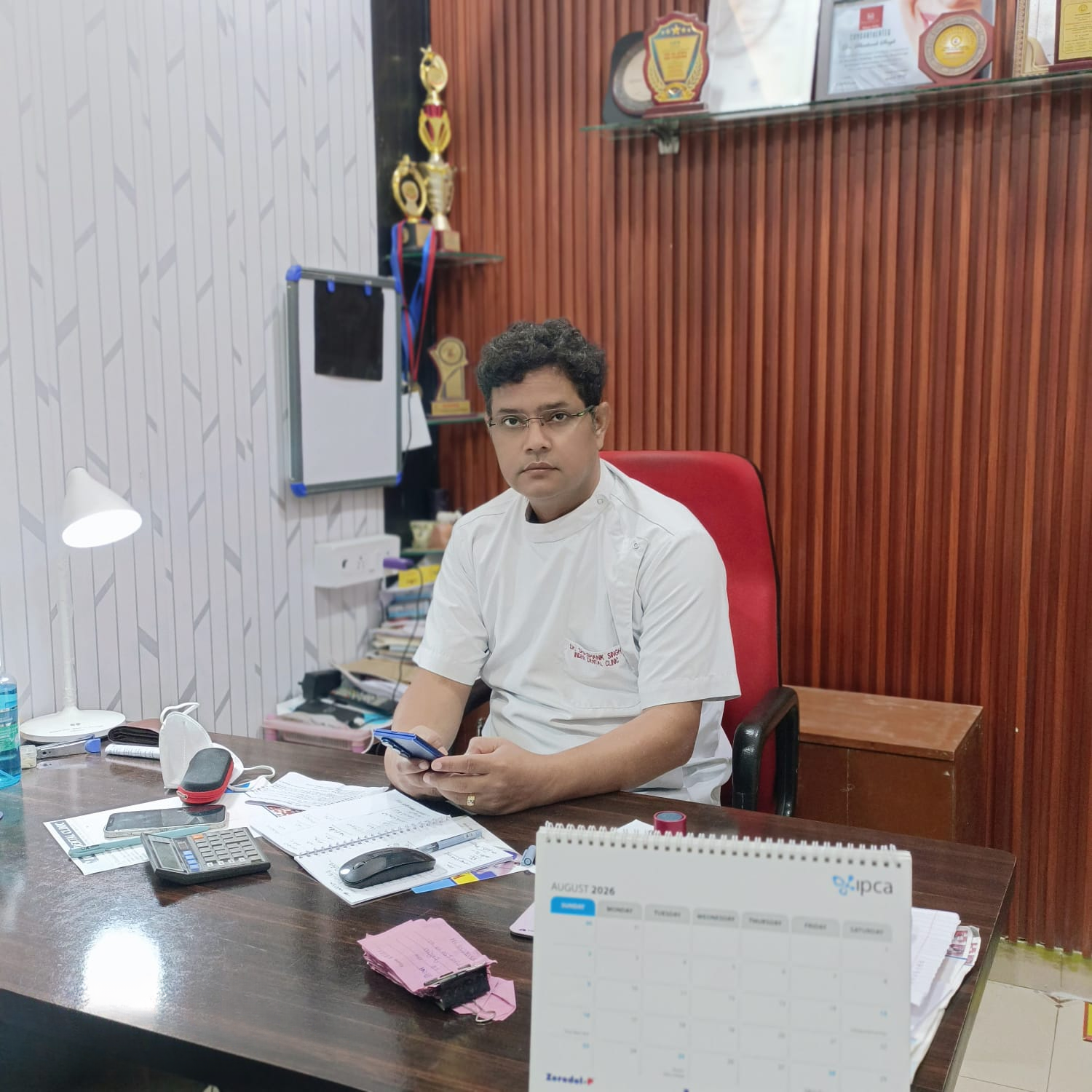 Smiling dentist at Inder Dental Clinic